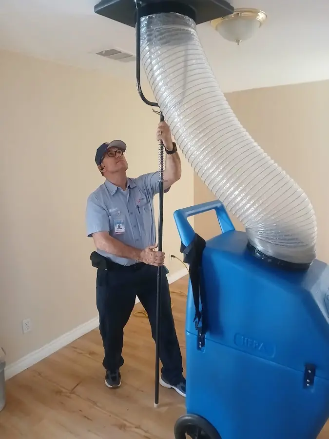 Furnace Tune-Up technician using HEPA equipment in Battlement Mesa